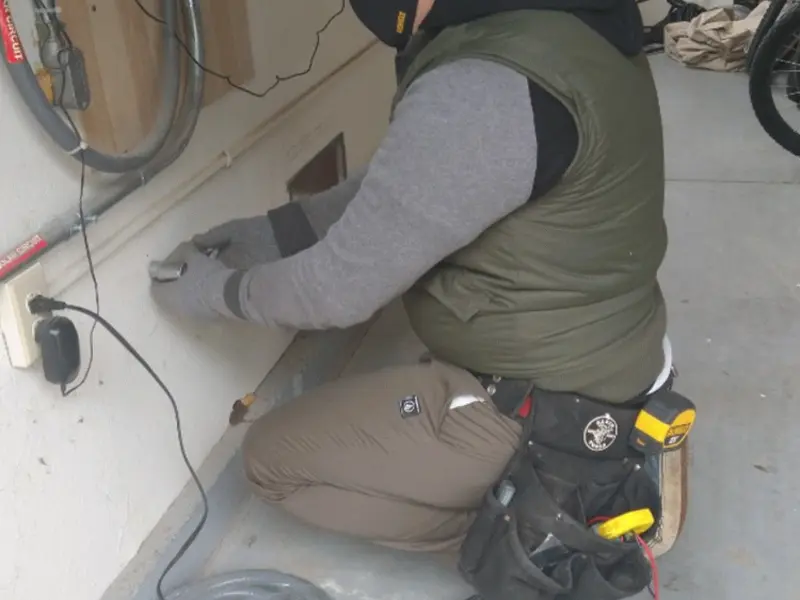 Electrician performing outlet wiring in a Wauconda garage